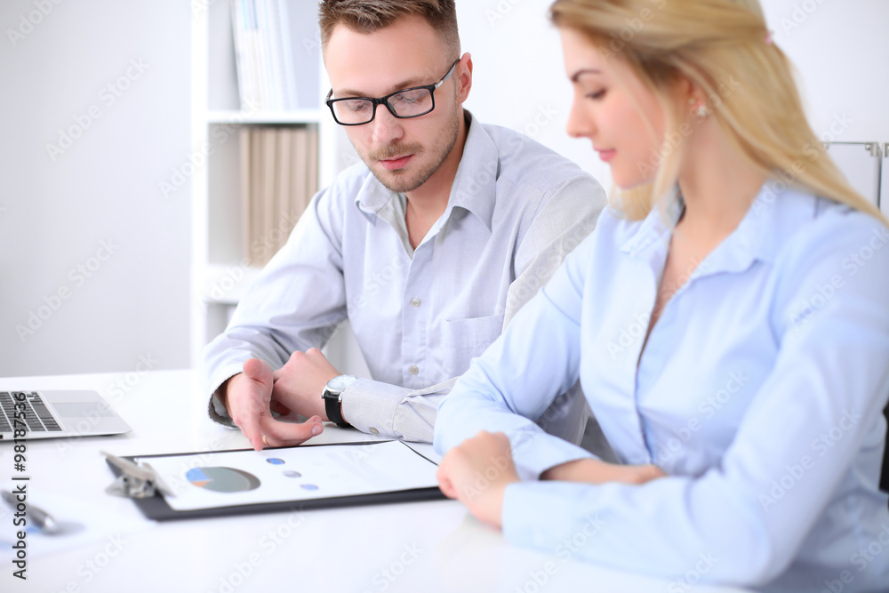 Two successful business partners working at meeting in office Two successful business partners working at meeting in office