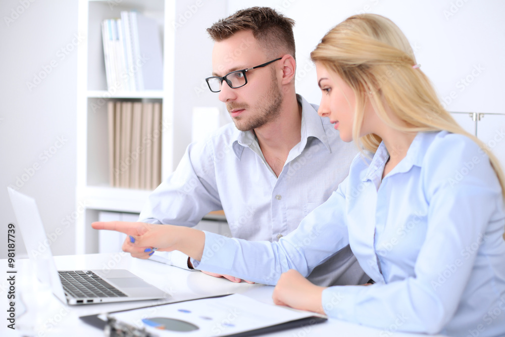 Two successful business partners working at meeting in office Two successful business partners working at meeting in office