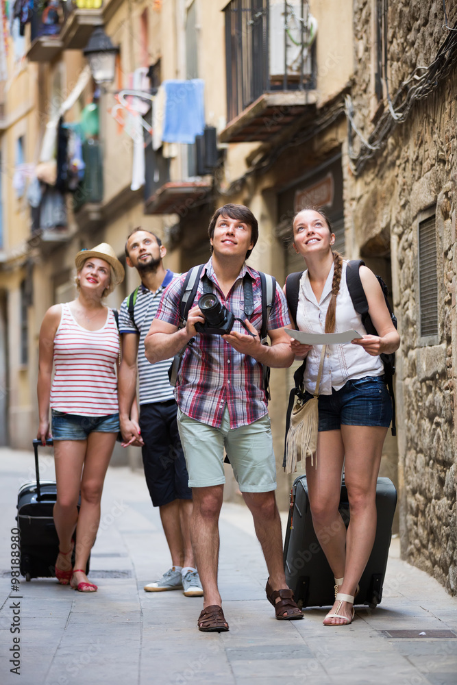 Positive tourists with camera and map