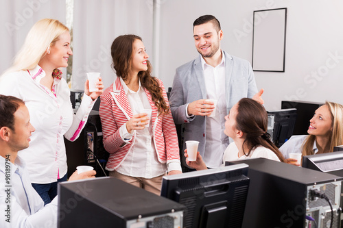 Happy employees and manager celebrating photo