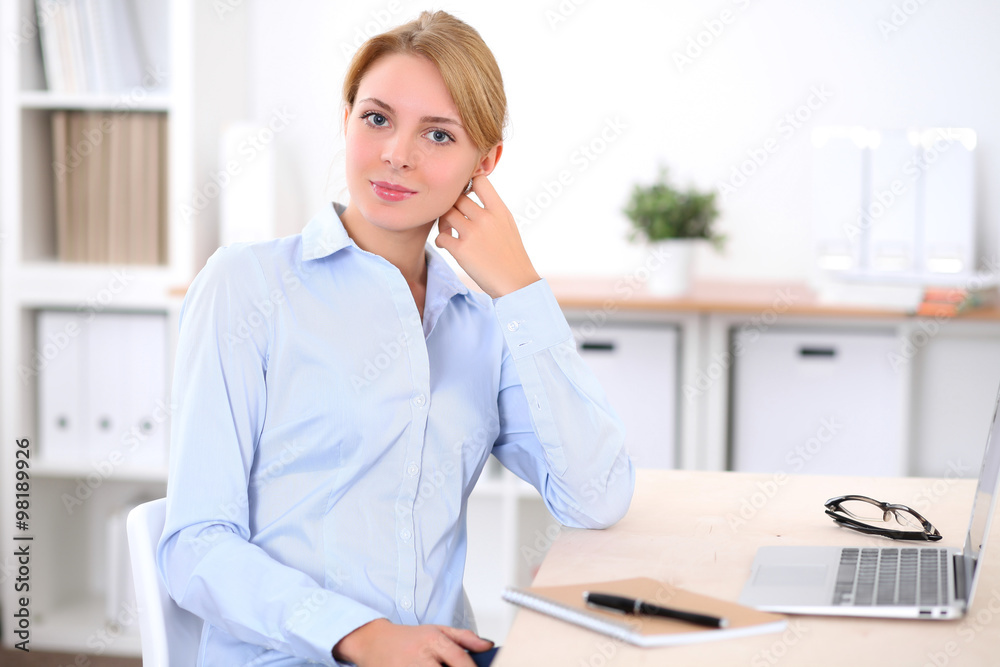Young blonde business woman with laptop in the office. Business concept. Young blonde business woman with laptop in the office. Business concept.