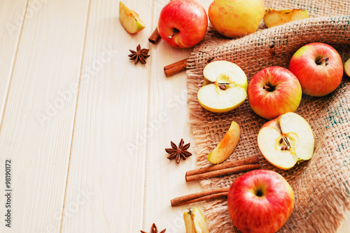  background, fresh apples with cinnamon and spices on a light wooden background