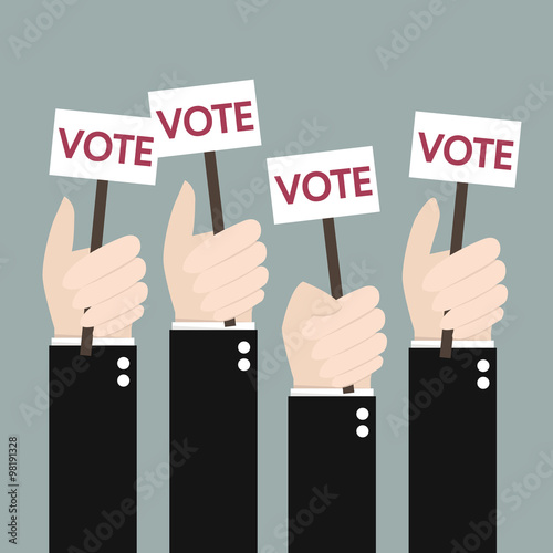 Businessmen holding a signboard with the word vote. A lot of han