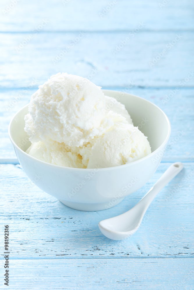 Ice cream in bowl on blue wooden background Ice cream in bowl on blue wooden background