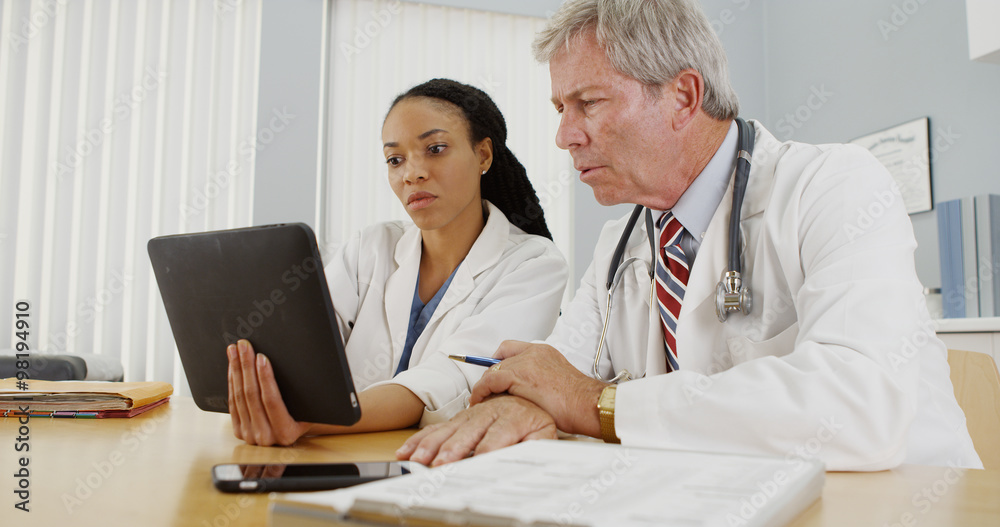 Two doctors working together in the office Two doctors working together in the office