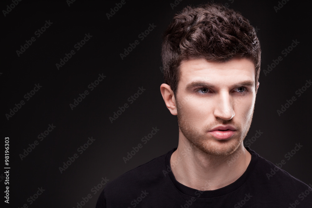 Obraz premium Stylish guy close up portrait on black background