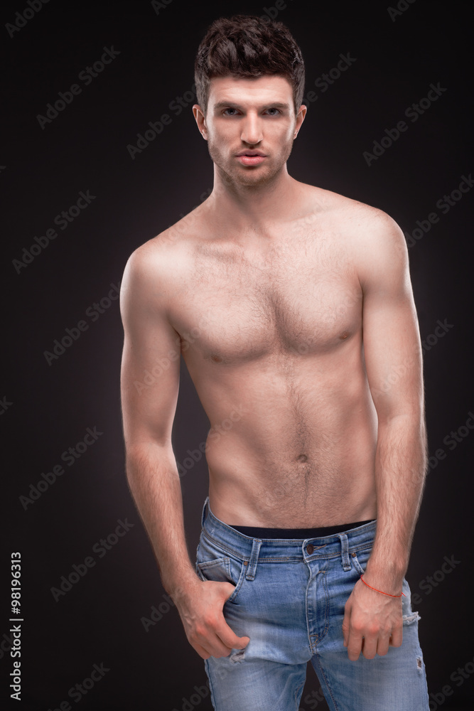 Sporty guy topless in jeans