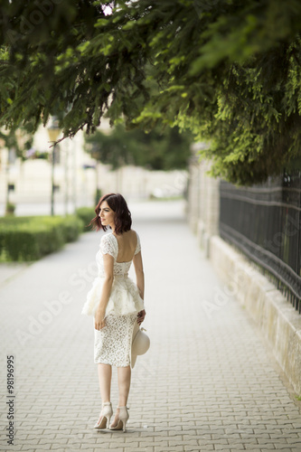Young woman in white drress at outdoors