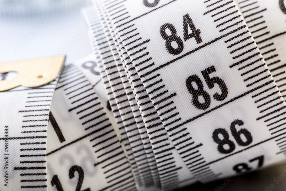 Curved measuring tape. Measuring tape of the tailor. Closeup view of white measuring tape Curved measuring tape. Measuring tape of the tailor. Closeup view of white measuring tape