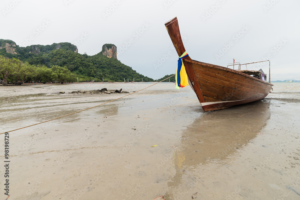Stranded taxi boat on beach in cloud day Stranded taxi boat on beach in cloud day