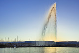 The famous fountain “Jet d'Eau” in Lake Geneva at sunset.