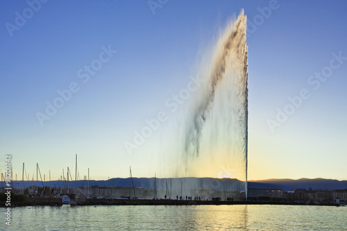 The famous fountain “Jet d'Eau” in Lake Geneva at sunset.
