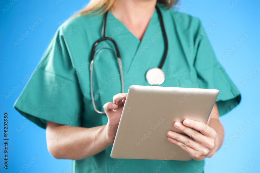 Female doctor at hospital working on a digital tablet Female doctor at hospital working on a digital tablet