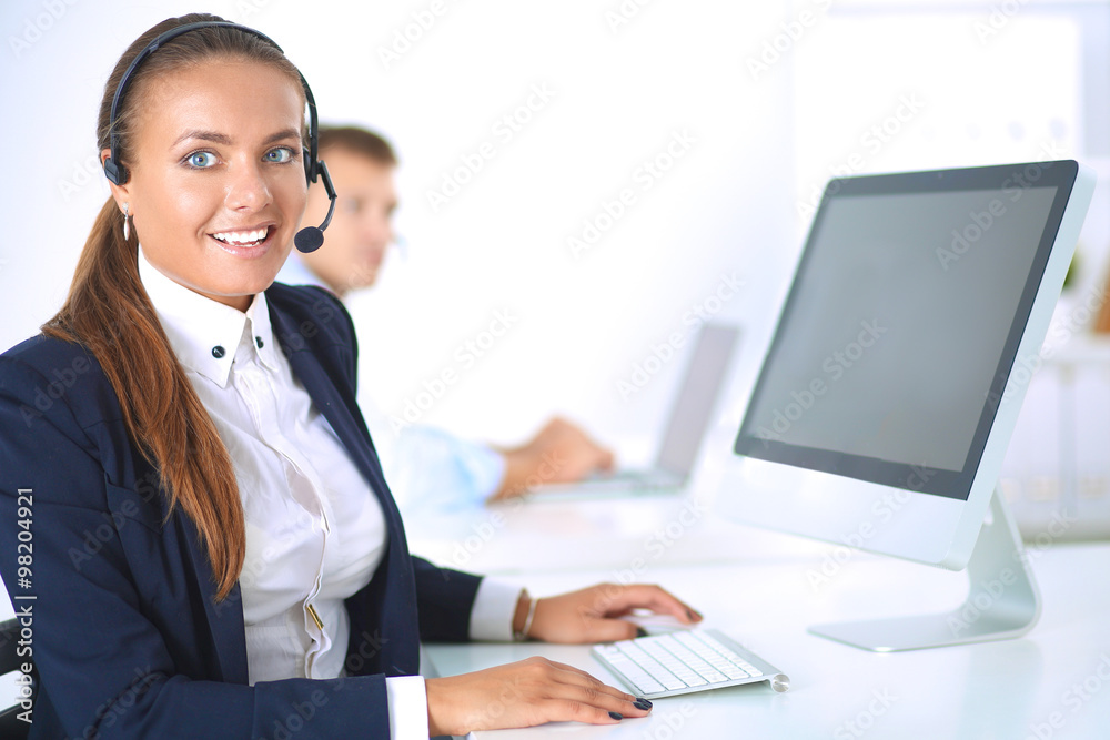 Happy female wearing headset and sitting on the desk Happy female wearing headset and sitting on the desk