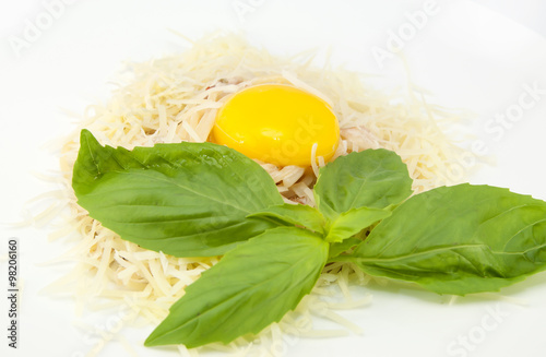 spaghetti with cheese and egg on a white plate in a restaurant