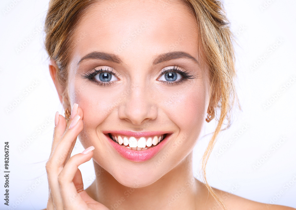 Young woman touching her face isolated on white background