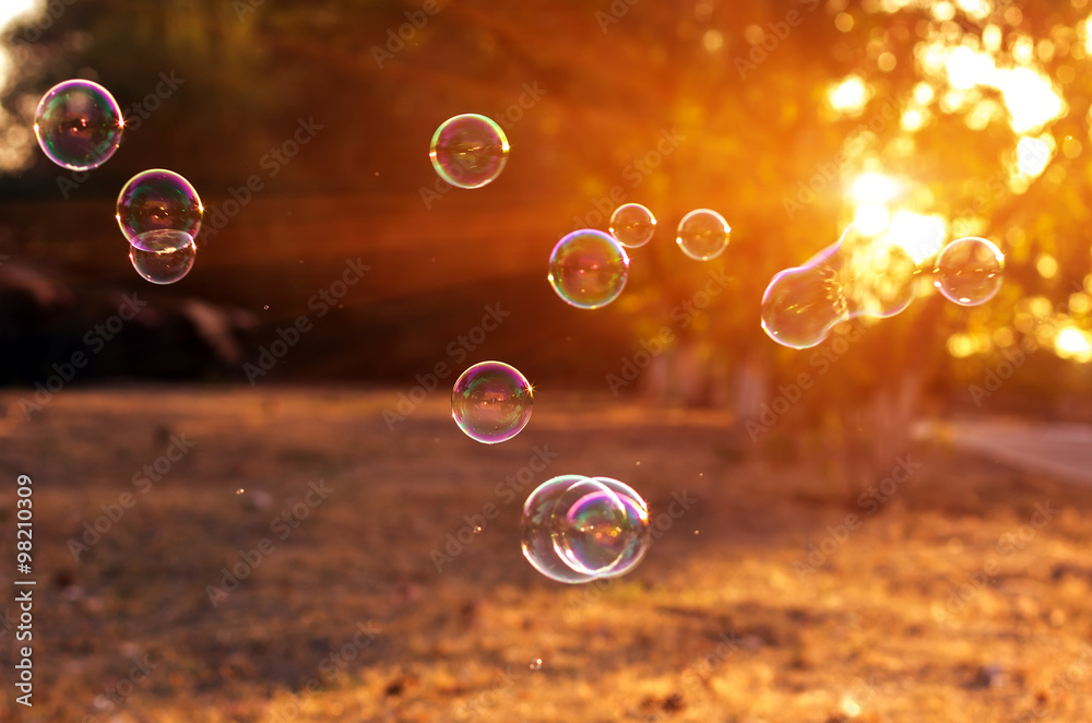 soap bubbles into the sunset .blurred