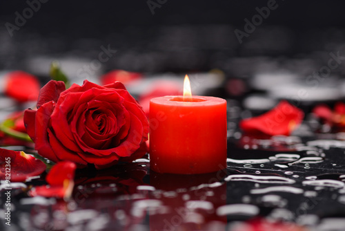 Red rose, petals with candle and therapy stones 