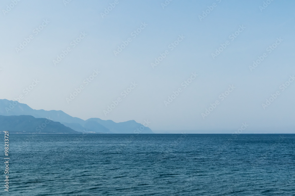 Sea on the background of mountains and sky