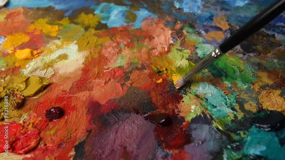 Mixing oil color on palette Stock Video | Adobe Stock