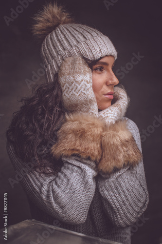  Woman in winter hat an fur gloves.