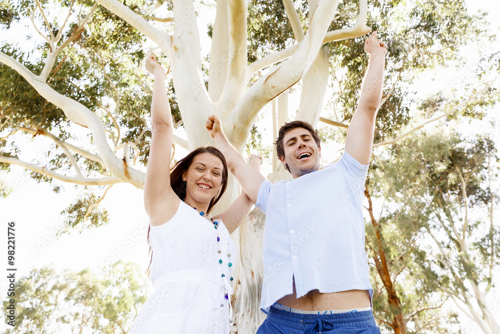 Young couple in the park celebrating Young couple in the park celebrating