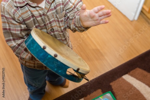 Small child playing on drum