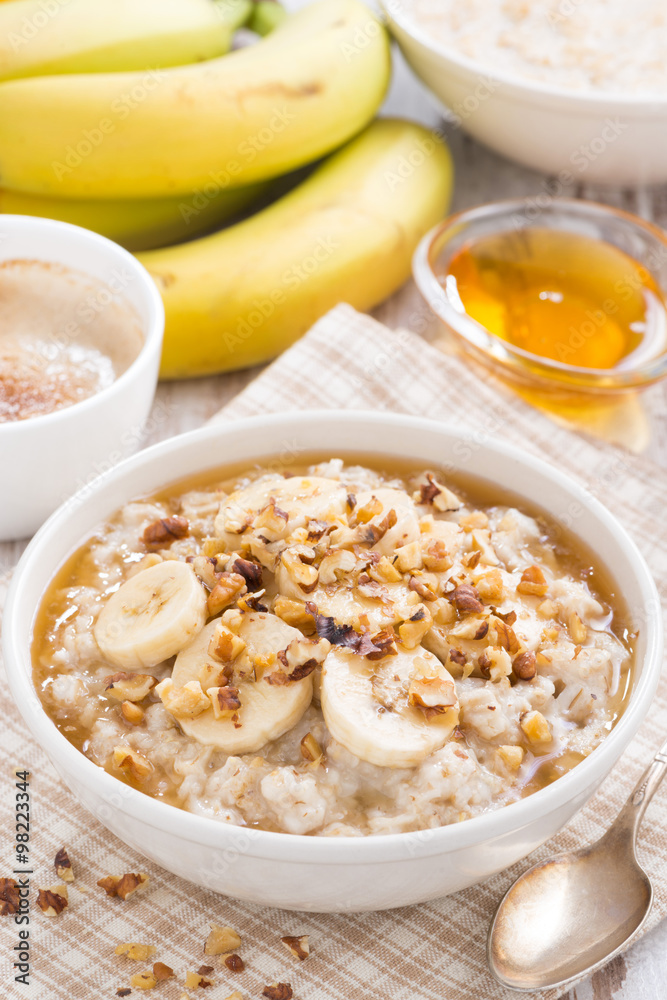 oatmeal with banana, honey and walnuts in bowl for breakfast oatmeal with banana, honey and walnuts in bowl for breakfast