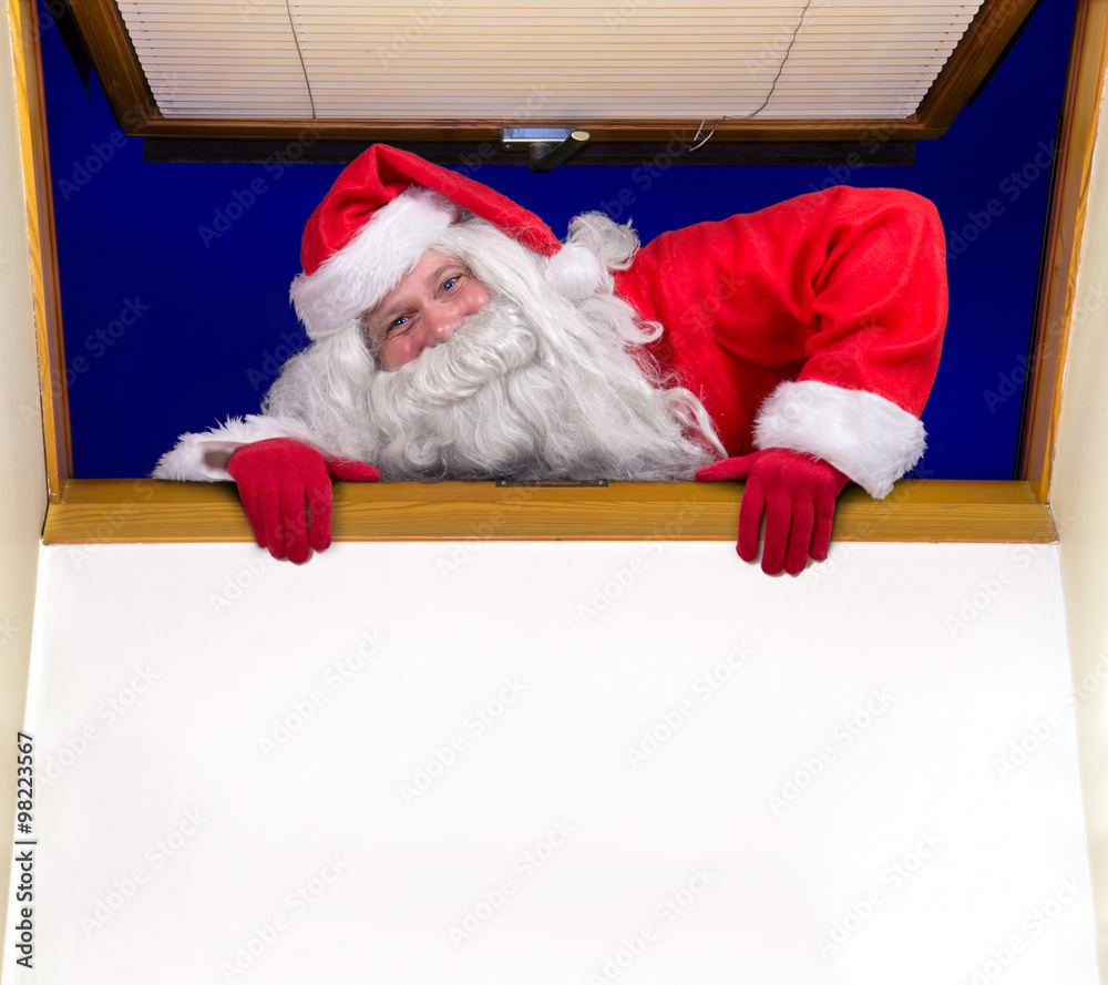 Naklejka premium Santa Claus climbs into the room through an open window