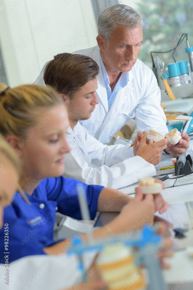 Technicians working in dental laboratory Technicians working in dental laboratory
