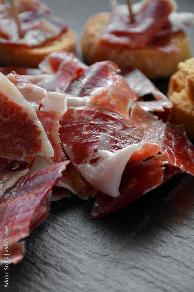 appetizer of ham Serrano with bread roasted appetizer of ham Serrano with bread roasted