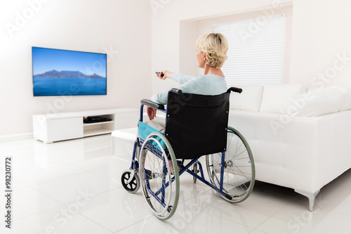 disabled senior woman watching tv