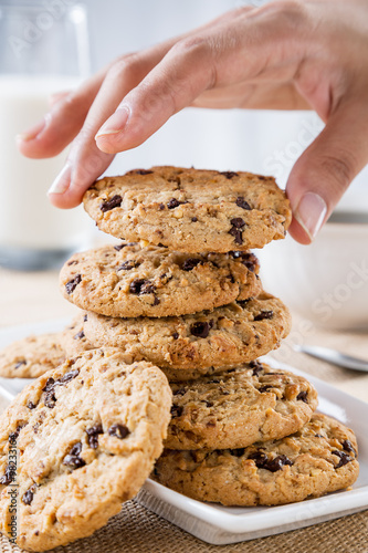 close up of hand taking cookie from stack 