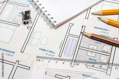 Construction planning drawings and three yellow pencils with ruler