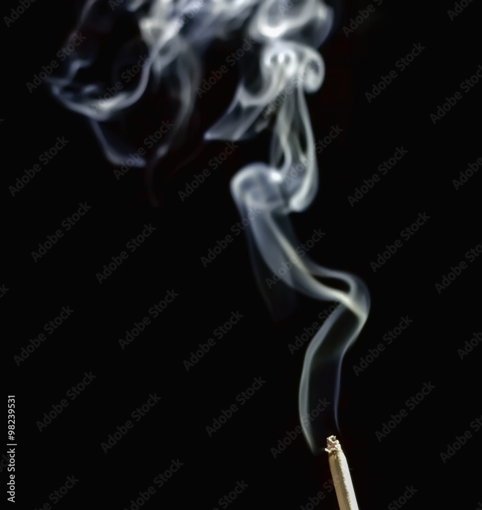 Cigarette with smoke on dark background