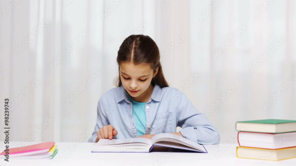 happy school girl reading book or textbook at home happy school girl reading book or textbook at home