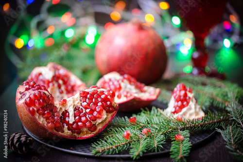 Wallpaper Mural Pomegranate with festive decorations over wooden background Torontodigital.ca