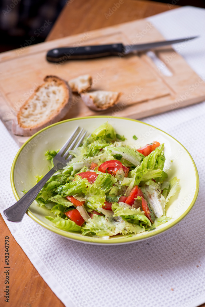 salad with lettuce leaves, cucumber and tomatoes