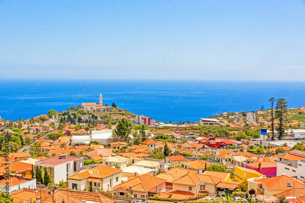 South coast of Funchal -view over the capital city of Madeira, district Sao Martinho with civila parish church. View from Pico dos Barcelo - Atlantic Ocean in the background.