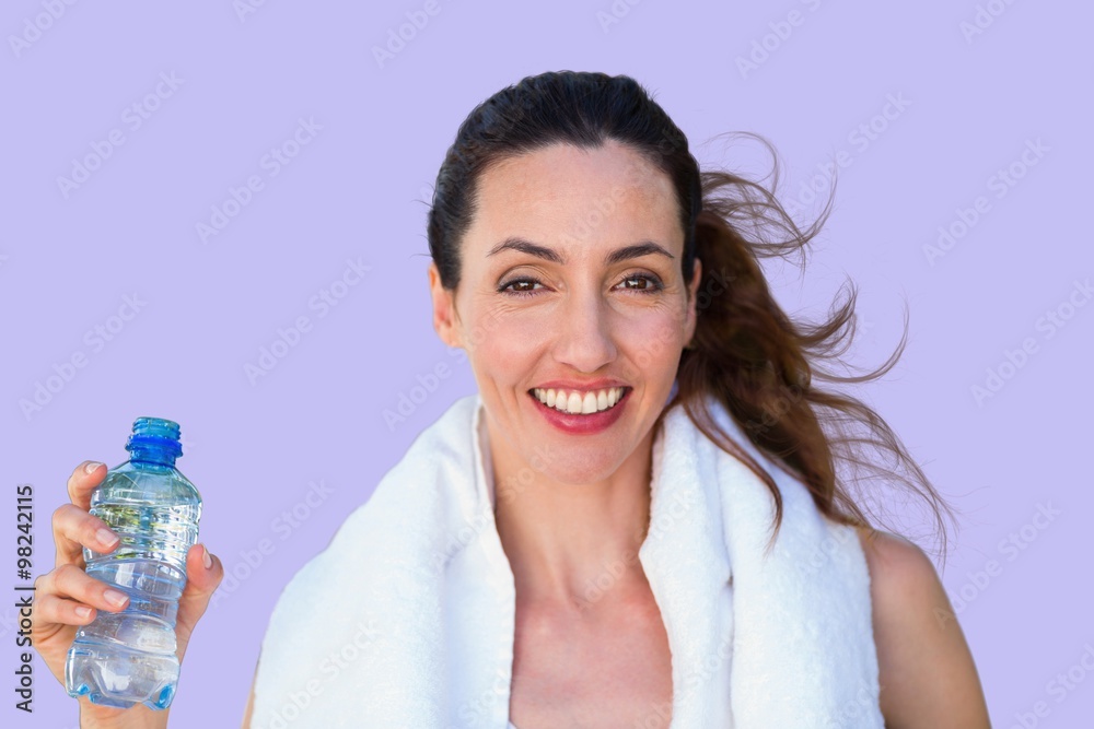 Composite image of beautiful brunette holding bottle of water Composite image of beautiful brunette holding bottle of water