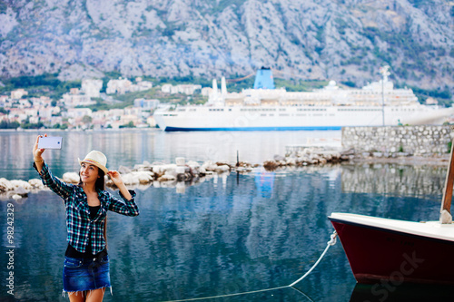 girl taking selfie photo on smartphone of cruise liner yacht © shevtsovy