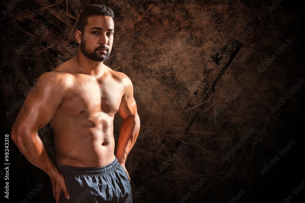 Fototapeta premium Composite image of portrait of confident bodybuilder man
