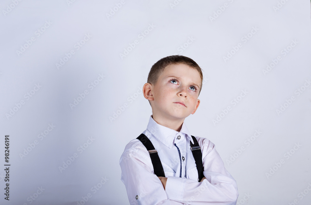 Thinking child-Portrait of a little boy thinking deeply about something with hand on chin looking to camera Thinking child-Portrait of a little boy thinking deeply about something with hand on chin looking to camera