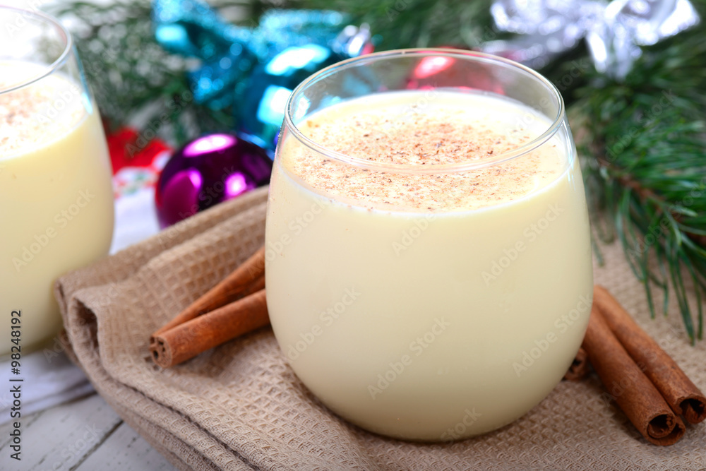 Glass of eggnog in a Christmas setting Glass of eggnog in a Christmas setting