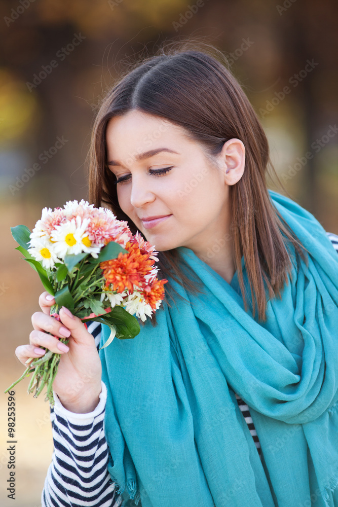 Young woman with bunch of wildflowers Young woman with bunch of wildflowers