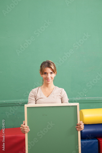 teacher holding a blackboard © implementarfilms