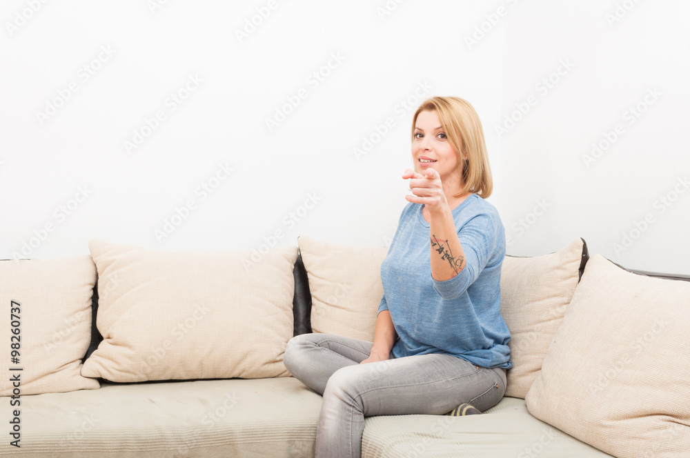 Modern woman sitting on a couch or sofa Modern woman sitting on a couch or sofa