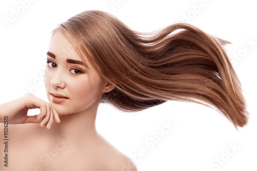 Very young girl with bushy hair flying.