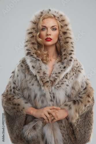 attractive lady in fur coat with hood