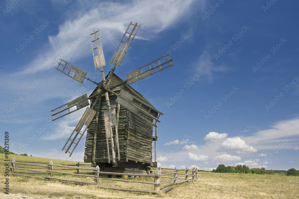 old wooden windmill in a field